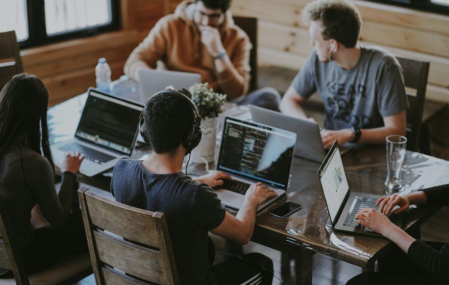 A group of people working together on laptops
